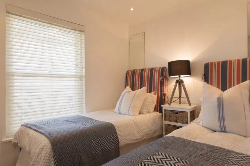 A furnished dual-bed bedroom at Just Right Housing